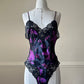 Vintage DIOR’s satin black bodysuit featuring vibrant purple floral prints