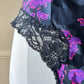 Vintage DIOR’s satin black bodysuit featuring vibrant purple floral prints