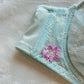 Baby blue Japanese brassiere featuring purple embroidered flowers