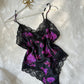 Vintage DIOR’s satin black bodysuit featuring vibrant purple floral prints